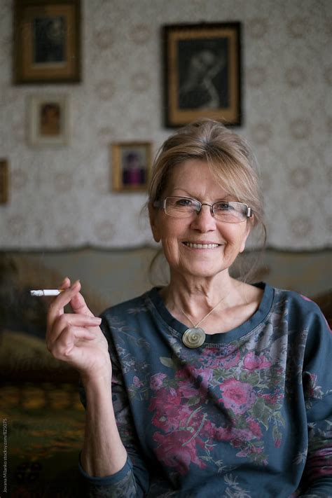 Beautiful Smily Senior Woman Sitting Indoors Smoking Cigaret Del