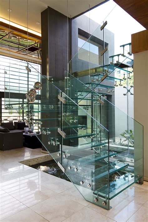 enthralling glass staircases that add sculptural style to your home