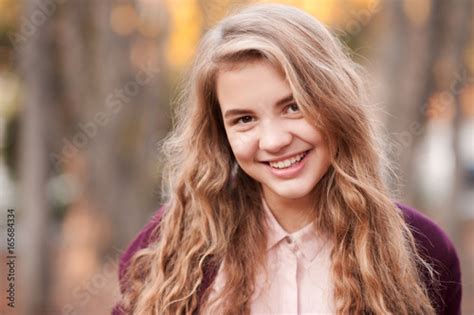 Smiling Blonde Teenage Girl 14 16 Year Old With Curly Long Hair