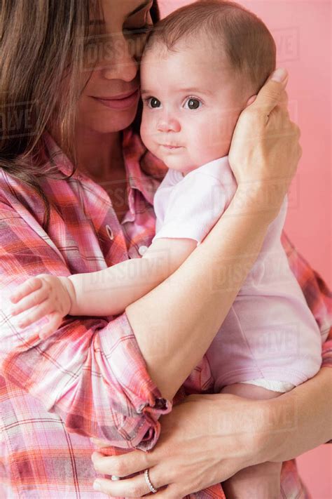Caucasian Mother Hugging Baby Daughter Stock Photo Dissolve