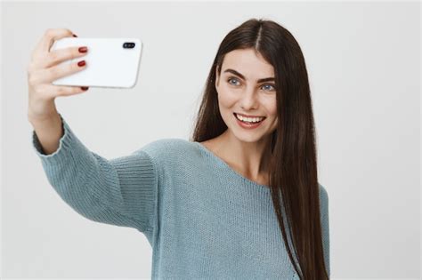 Free Photo Smiling Beautiful Woman Taking Selfie On Smartphone
