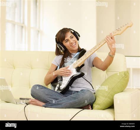 Mid Adult Woman Playing Electric Guitar Stock Photo Alamy