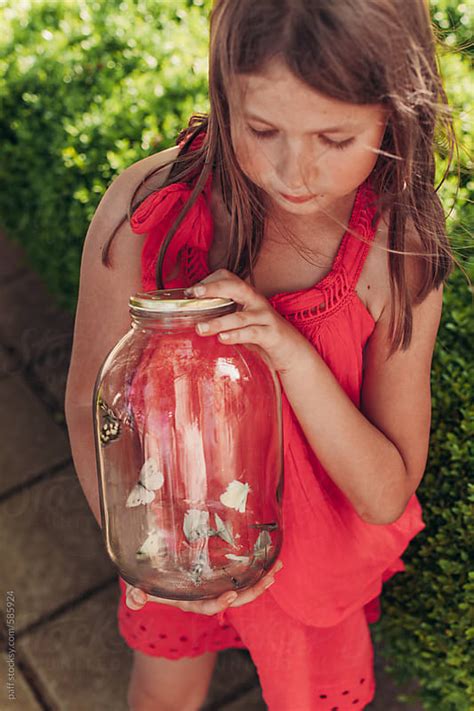Portrait Of A Beutiful Little Girl Examining Butterflies Captured In A
