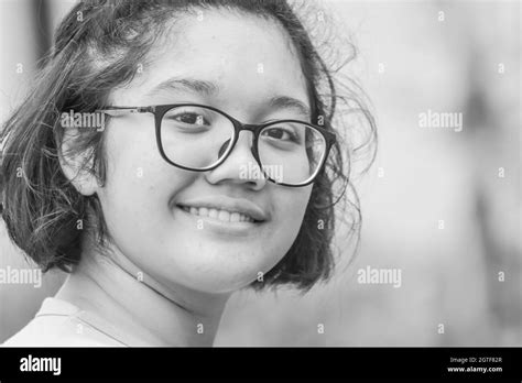 Close Up Portrait Of A Teenage Girl Wearing Glasses Smiling At The