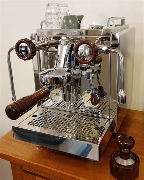 An Espresso Machine Sitting On Top Of A Wooden Table