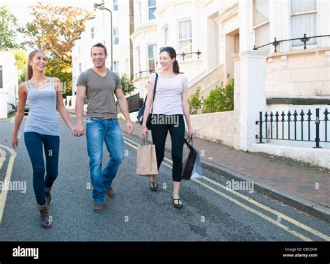 Friends Walking On Village Street Stock Photo Alamy