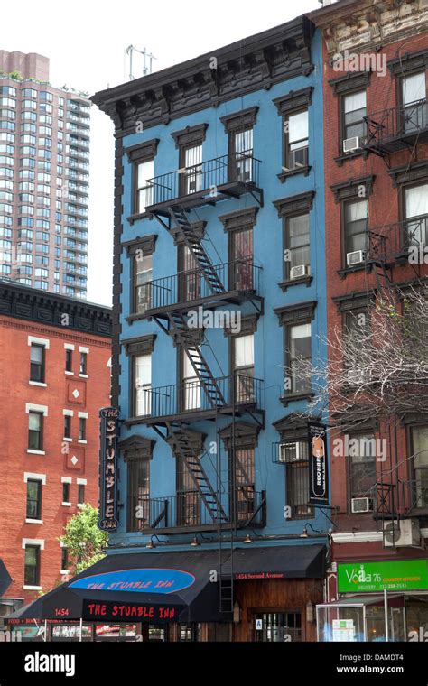 Colorful Apartment Buildings With Fire Escapes In New York City Stock