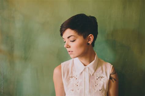 Girl With Short Hair In Front Of Green Wall By Gabrielle Lutze