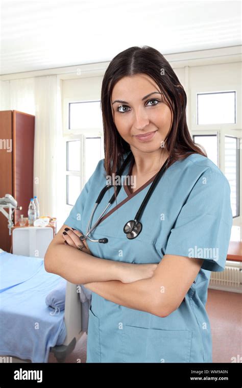 A Beautiful Young Brunette Female Doctor Or Nurse Standing In A