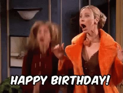 A Woman In An Orange Jacket Is Singing Into A Microphone With The Words Happy Birthday Written On It
