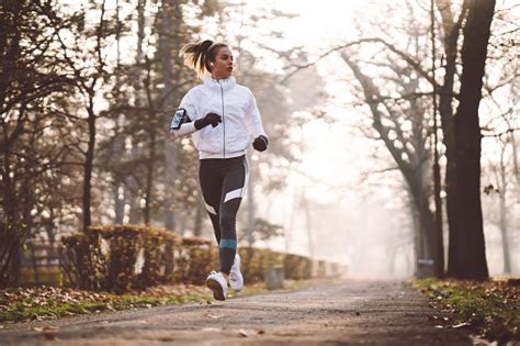 Woman Jogging During Winter Morning Stock Photo Download Image Now