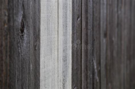 Do It Yourself Natural Wooden Fence With A Piece Of Wood In Front Stock