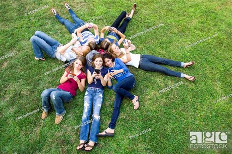 Friends Hanging Out Together On Grass Stock Photo Picture And Royalty