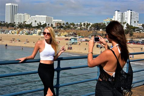 Girls Taking Photo On Santa Monica Pier In Santa Monica California Encircle Photos