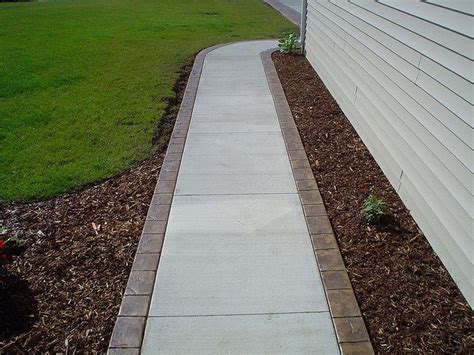 The problem is there's a concrete border around the stones. regular concrete with brick border | Concrete patio ...