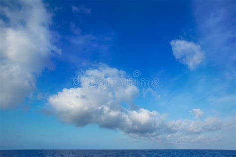 Cumulus Clouds In Blue Sky Over Water Horizon Stock Photo Image Of