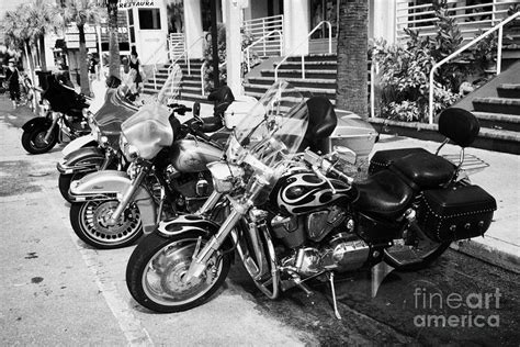 Row Of Honda And Harley Davidson Motorcycles Parked In Key West During