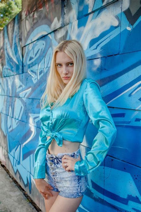 Young Girl Blonde Poses On A Background Of A Wall With Graffiti Stock Image Image Of Cute