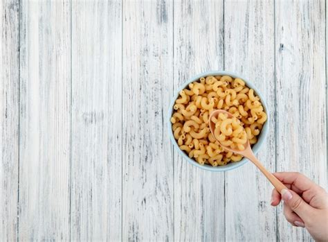 Free Photo Top View Elbow Macaroni Pasta In Bowl On The Right With