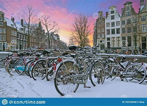 City Scenic From Snowy Amsterdam At Sunset In The Netherlands Stock