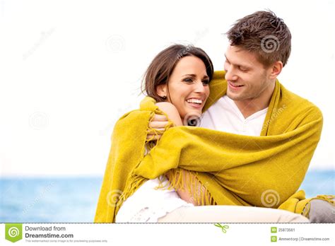Couple Wrapped With Blanket Embracing Stock Image - Image of attractive, affection: 25873561