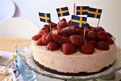 A Cake Decorated With Flags And Strawberries On A Table