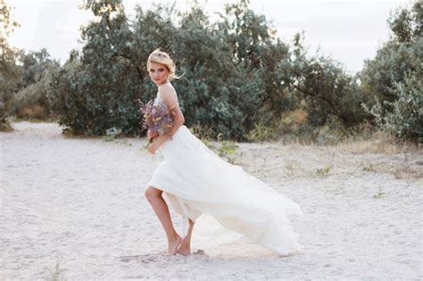 Premium Photo Model In A Beige Wedding Dress On The Beach In Summer