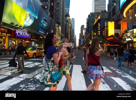 Visitors To Times Square In New York Pass The Manhattanhenge Sunset