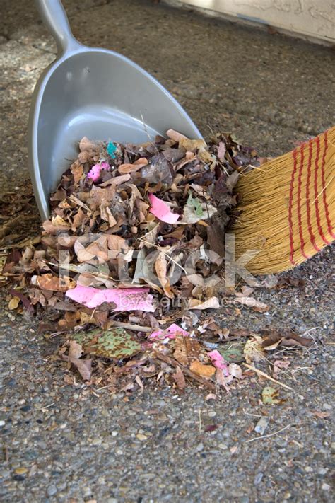 Straw Broom Sweeping Trash And Leaves Into Dust Pan Stock Photos