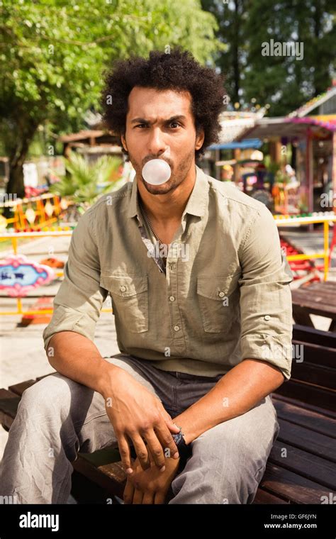 Portrait Of Young Man Blowing Bubble Gum Stock Photo Alamy