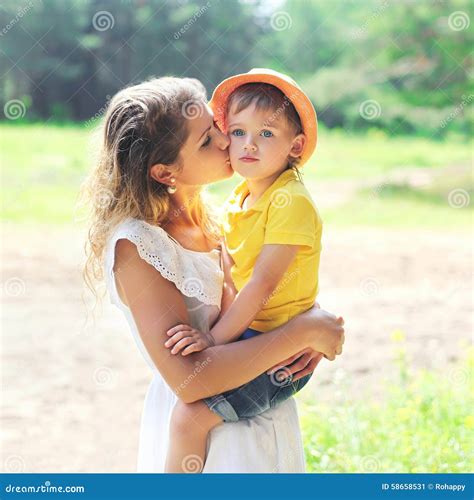 Mother Kissing Child Outdoors In Sunny Summer Stock Image Image Of