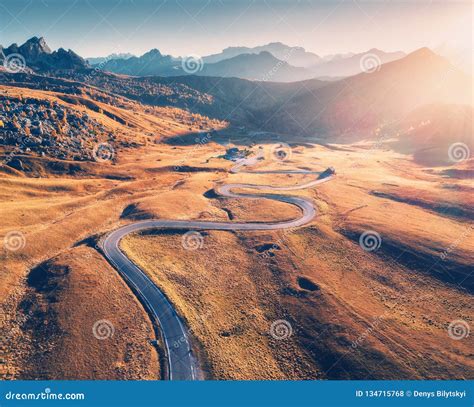 Winding Road In Mountain Valley At Sunset In Autumn Aerial View Stock