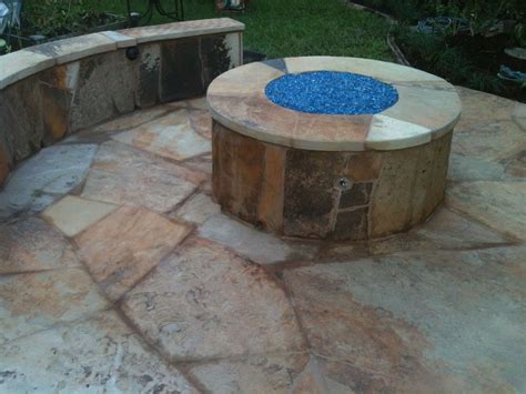 A Fire Pit Sitting On Top Of A Stone Patio