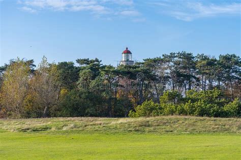 a brick lighthouse with a bright blue sky in the background picture of falsterbo lighthouse