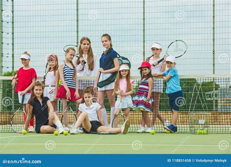 Portrait Of Group Of Girls As Tennis Players Holding Tennis Racket