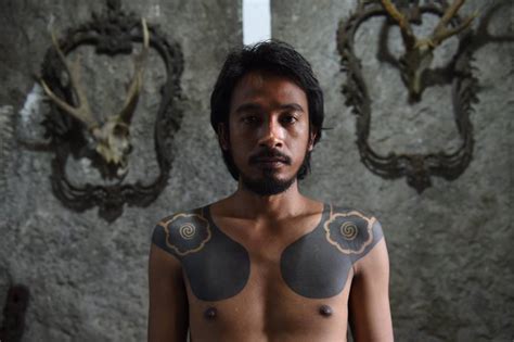 One moment please · ·. Indonesian tattooists revive tribal traditions by tapping ...