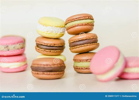 Many Multi Colored Macaroon Cakes In Stacks On A Light Background Stock