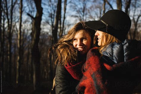 Two Smiling Girls Having Fun Together In The Woods By Stocksy Contributor Michela Ravasio