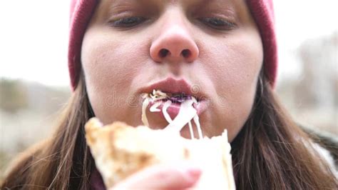 A Girl With Hungry Eyes Eats Shawarma With Pleasure Vegetables Stick Out Of Her Mouth Hd