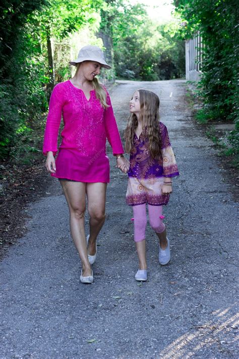 Premium Photo Mature Blonde In Pink And Her Young Daughter Walking In
