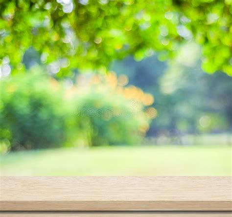 Empty Wood Table Over Blurred Trees With Bokeh Background Stock Photo