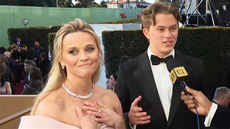 reese witherspoon gets emotional over son deacon s praise as her golden globes date exclusive
