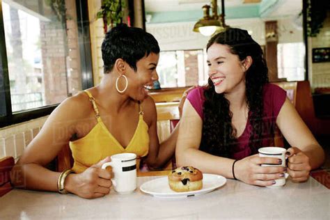 Women Having Coffee Together In Restaurant Stock Photo Dissolve