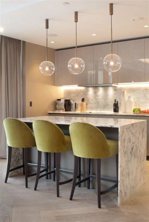 Find kitchen island chairs with backs here The curved backs of the upholstered bar stools add a soft ...