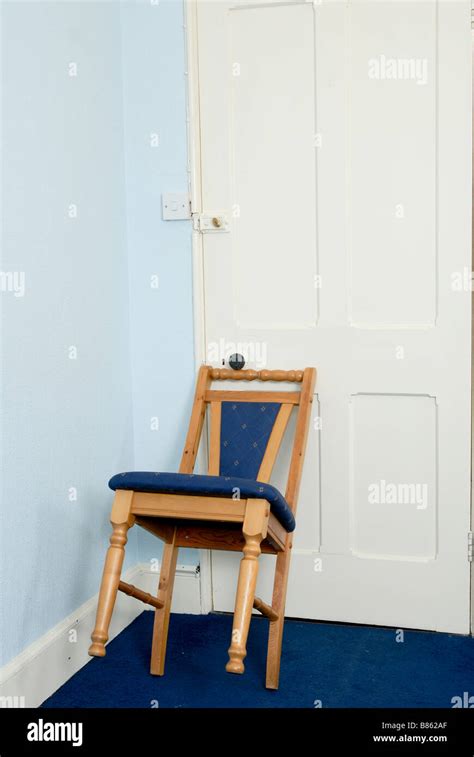 Chair Being Used To Secure A Door And Stop It Being Opened Stock Photo