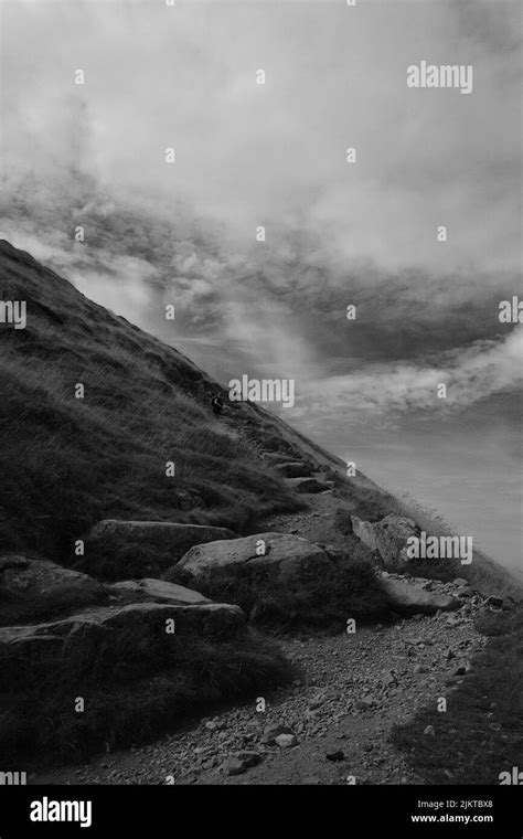A Grayscale Of A Rocky Hill Under The Cloudy Sky Stock Photo Alamy