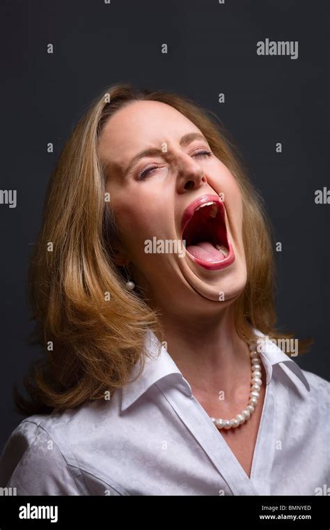 Portrait Of Woman With Open Mouth As If Shouting Singing Or Screaming
