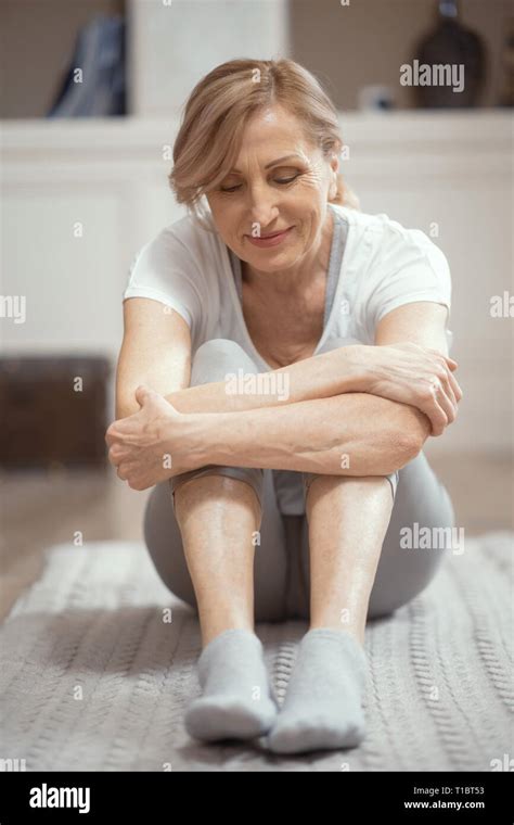 European Looking Woman Over 50 Years Old Doing Yoga At Home In The
