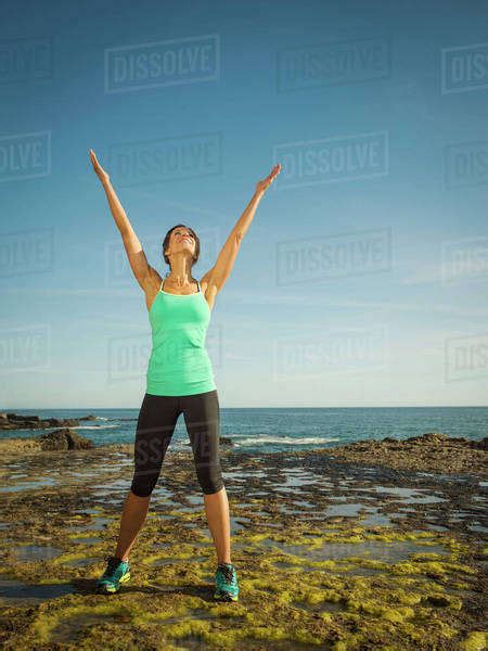 Caucasian Runner Smiling On Beach Stock Photo Dissolve