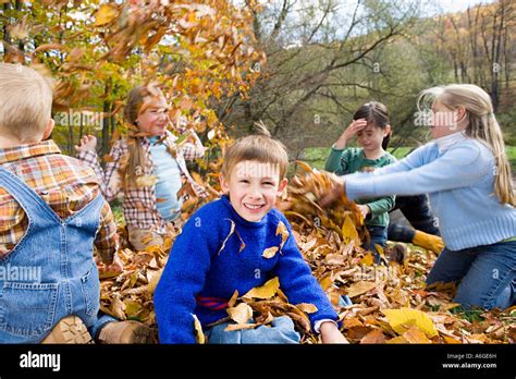 Kids Playing In Leaves Stock Photo Alamy